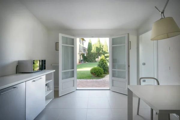 White kitchen with French doors opening onto the garden