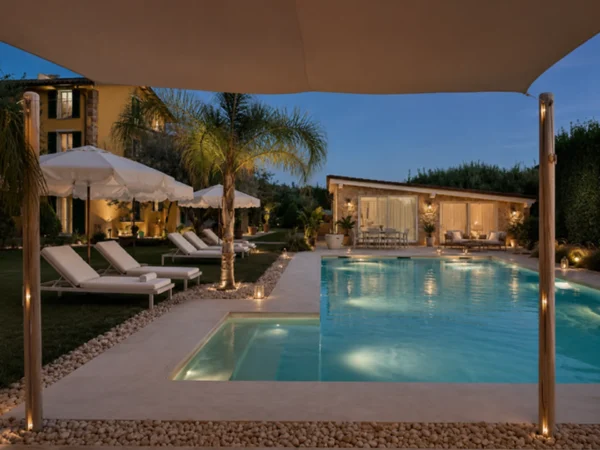 The illuminated pool of our holiday apartments in Pietrasanta at dusk